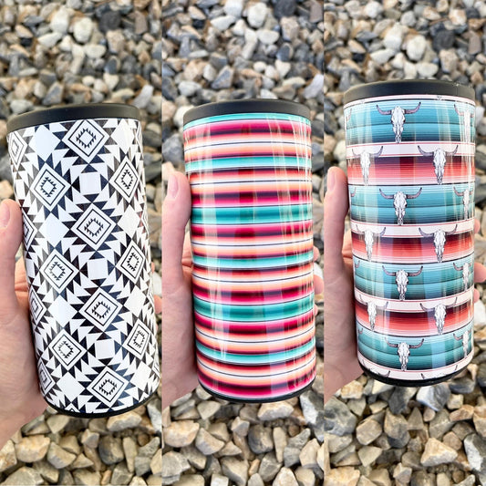 Protect your favorite canned beverages with the 12 OZ Slim Can Insulated Can Cooler. Crafted from durable hard material, this can cooler is designed to keep your drinks cold and stop condensation. The 12 ounce size is perfect for most canned drinks and the western prints adds a touch of style to any gathering! Choose from teal, pink, white, & orange serape OR teal, pink, red, white and black with bull skull heads. Either way you can’t go wrong! 